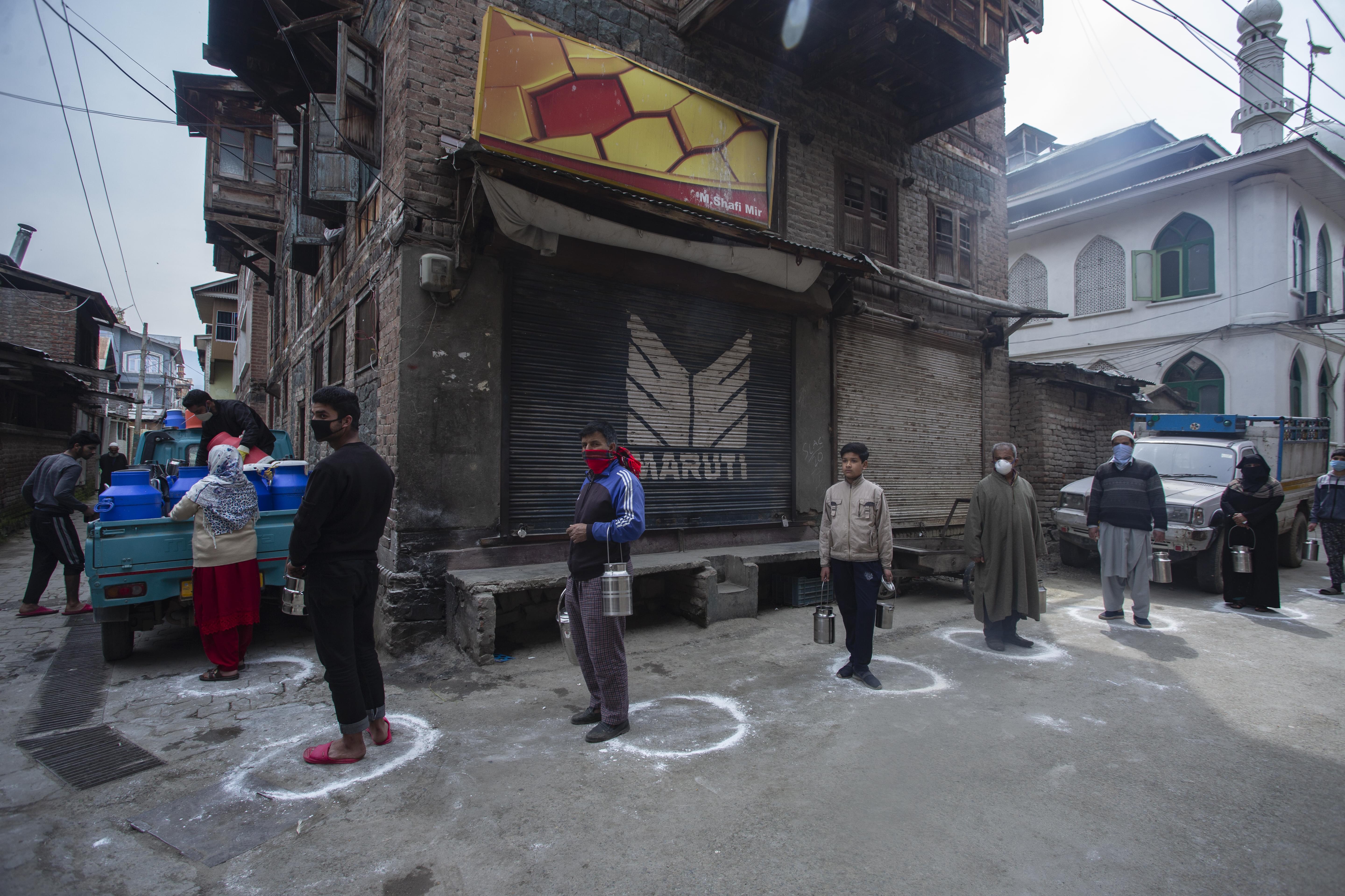 People queue for milk during the pandemic in Kashmir. Photo by Abid Bhat, used with permission.