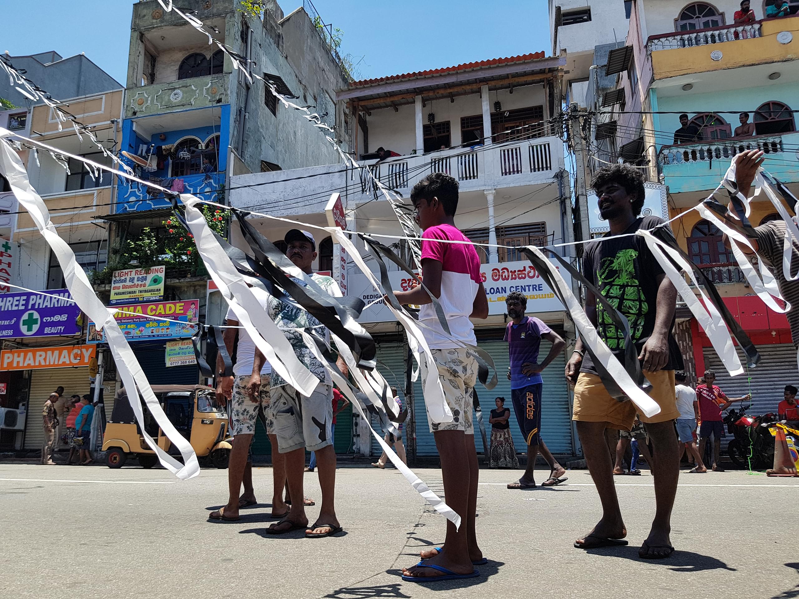 Mourners hang white flags in Sri Lanka, following the 2019 bombings of churches around the country. Photo by Groundviews (CC BY-ND 3.0)