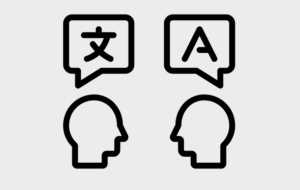Abstract graphic of two heads talking, with speech bubbles containing characters from different languages.